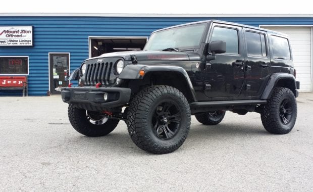 2014 Jeep Wrangler MetalCloak 2.5 lift on KMC Crank 18x9 Matte Black 0mm Offset and 35x12.50R18 Nitto Ridge Grappler Tires front driver side grille view
