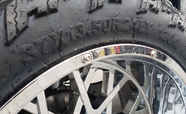 37x13.50r24LT tire on chrome wheel close up