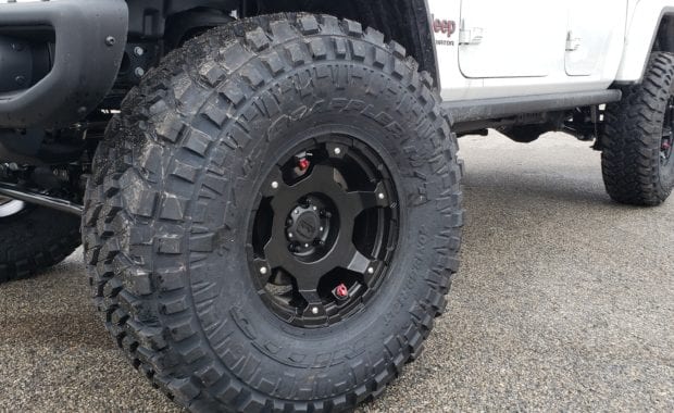 Lifted White Jeep Gladiator on Black wheel and Nitto tires front driver side wheel