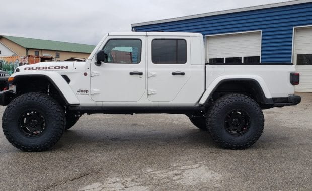 Lifted White Jeep Gladiator on Black wheel and tires passenger side view
