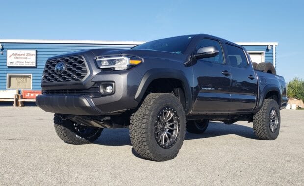Tacoma with Fuel Rebel D680 Wheel 18x9 6x5.5 (6x139.7) Matte Gunmetal Black 1MM Wheels and LT285/65R18/10 125/122R BFG ALL TERRAIN T/A KO2 Tires front driver side grille view