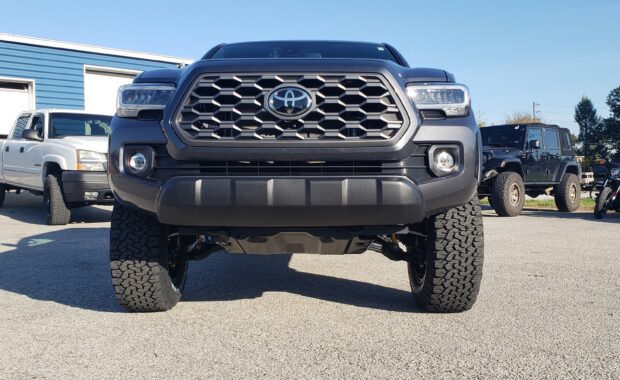 Tacoma with LT285/65R18/10 125/122R BFG ALL TERRAIN T/A KO2 Tires front grille view