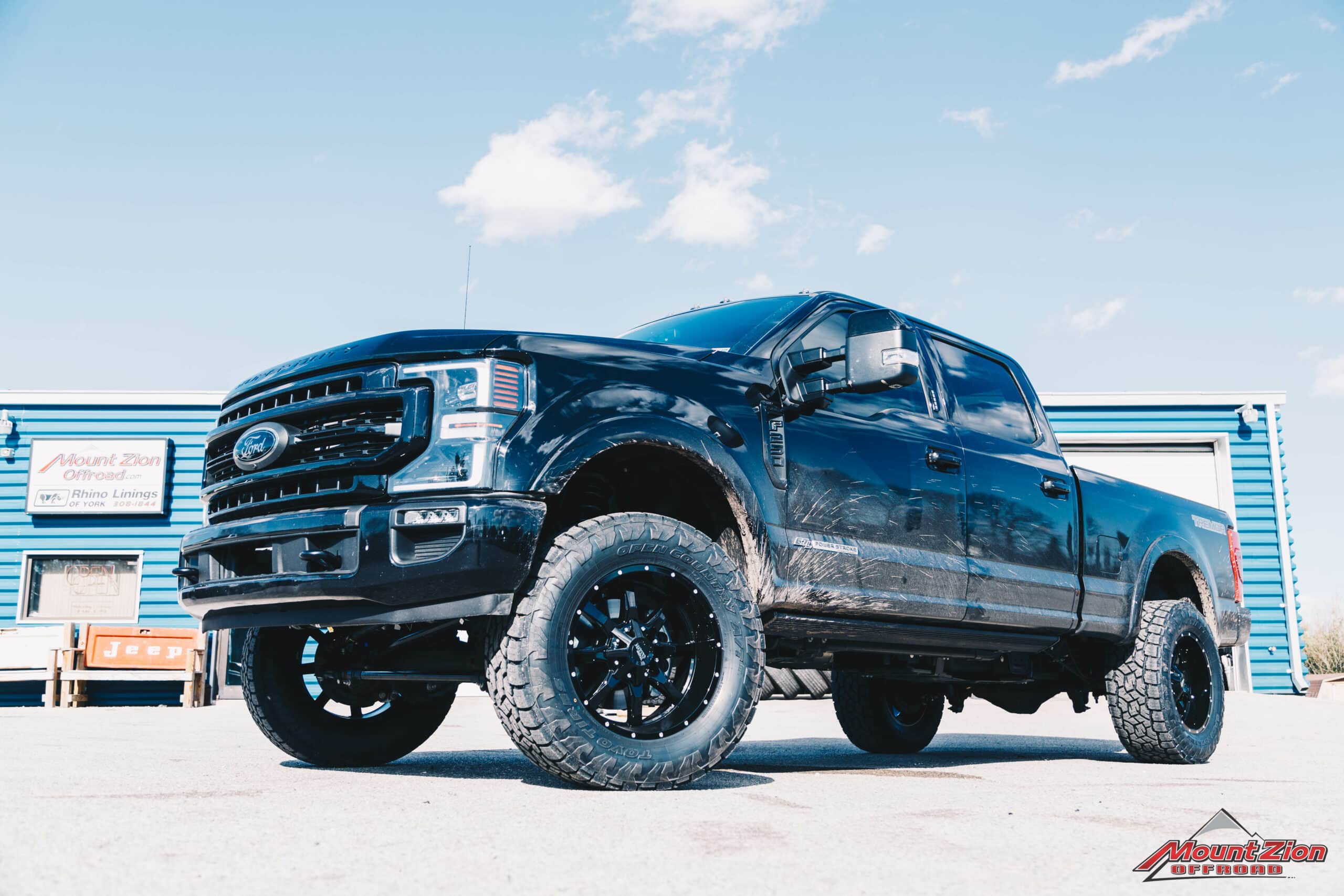 |Moto Metal MO970 20X10 -18 Black with Milled Lip Accent 8X170 wheels and 325/60R20 Toyo Open Country AT3 tires|21 F250 with 2" Leveling Kit on Moto Metal MO970 20X10 -18 Black with Milled Lip Accent 8X170 wheels and 325/60R20 Toyo Open Country AT3 tires driver side view|21 F250 with 2" Leveling Kit on Moto Metal MO970 20X10 -18 Black with Milled Lip Accent 8X170 wheels and 325/60R20 Toyo Open Country AT3 tires driver side tailgate view|21 F250 with 2" Leveling Kit on Moto Metal MO970 20X10 -18 Black with Milled Lip Accent 8X170 wheels and 325/60R20 Toyo Open Country AT3 tires rear passenger side tailgate view|21 F250 with 2" Leveling Kit on Moto Metal MO970 20X10 -18 Black with Milled Lip Accent 8X170 wheels and 325/60R20 Toyo Open Country AT3 tires passenger side view|21 F250 with 2" Leveling Kit on Moto Metal MO970 20X10 -18 Black with Milled Lip Accent 8X170 wheels and 325/60R20 Toyo Open Country AT3 tires front passenger side grille view