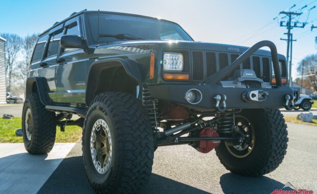 Green Jeep Cherokee with winch and push bar