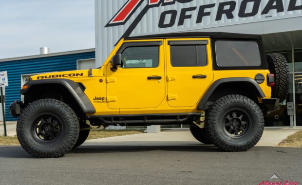 Lifted yellow Rubicon on 38's, side view