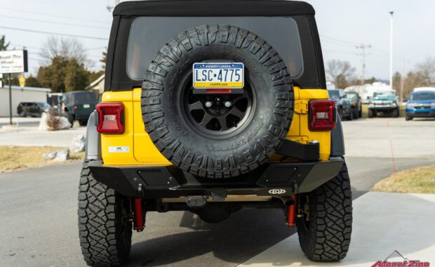 Lifted yellow Rubicon on 38's, rear view