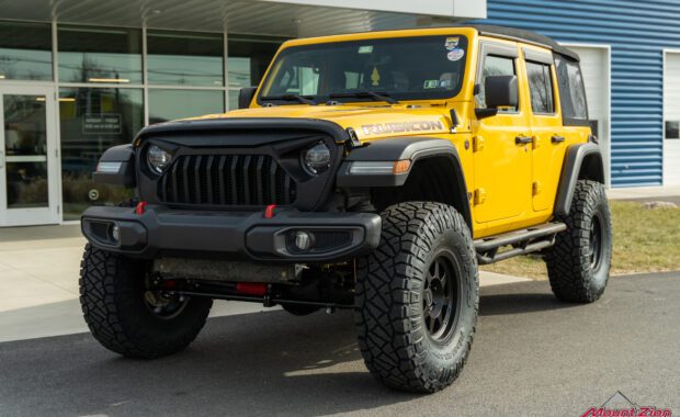 Lifted yellow Rubicon on 38's, front driver side corner view