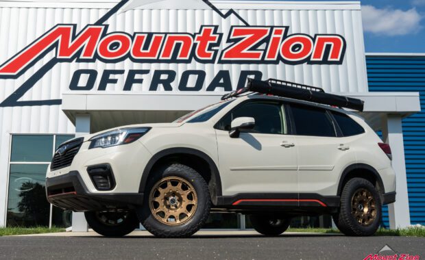 White 2019 Subaru Forester Sport with method wheels and falken tires on 2019 subaru forester sport with roof basket in front of mount zion shop