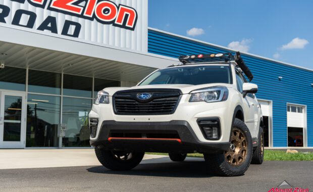 White 2019 Subaru Forester Sport with method wheels and falken tires on 2019 subaru forester sport with roof basket in front of mount zion offroad shop