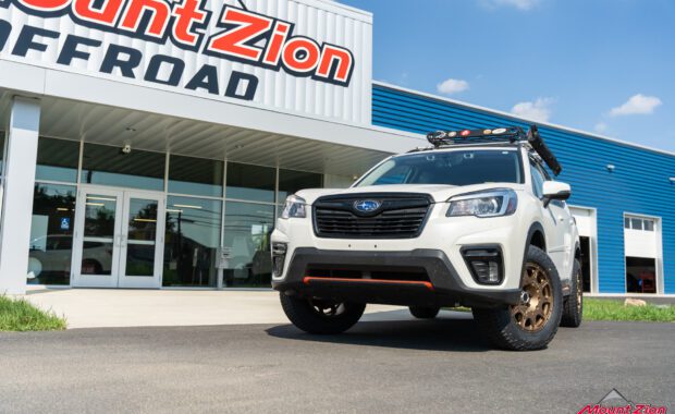 White 2019 Subaru Forester Sport with method wheels and falken tires on 2019 subaru forester sport with roof basket passenger side view at mount zion offroad