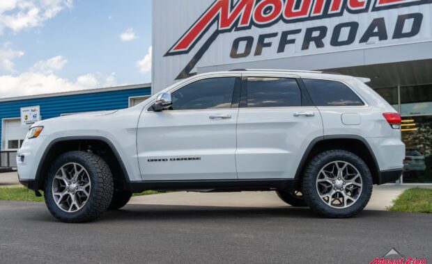 white Jeep grand cherokee with Nitto Tires driver side view at mount zion offroad