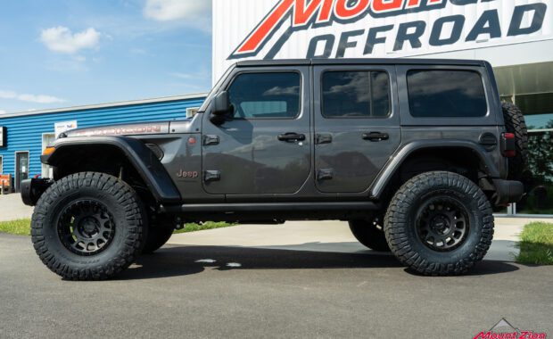 2022 Jeep Wrangler Unlimited Rubicon in Granite Crystal with Method 305 and Nitto Ridge Grappler 37x12.50R17 driver side shot