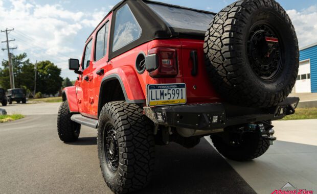 Red 2018 Jeep Wrangler Unlimited Sahara driver side rear end