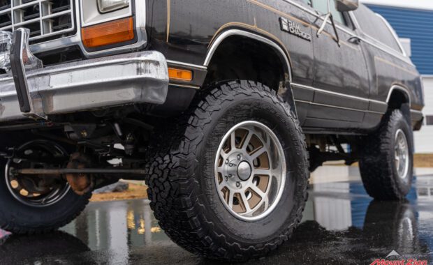 Black with Gold Stripping 1985 dodge ram charger BFgoodrich tire low ground driver side view