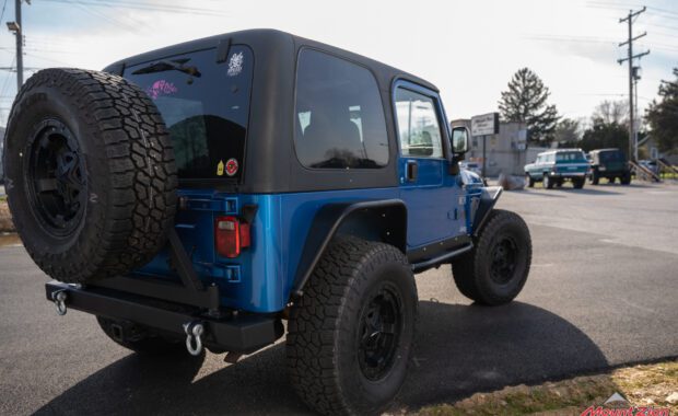 intense blue 2003 jeep wrangler with metal cloak step and fender on falken wildpeak tires rear passenger side tailgate