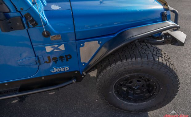 intense blue 2003 jeep wrangler with metal cloak step and fender