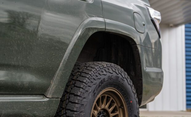 2022 toyota 4runner with bronze kmc wheels and falken wildpeak tires rear driver side view