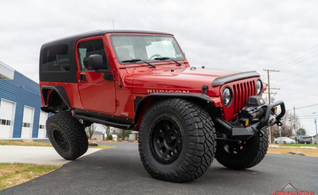2005 two door jeep wrangler unlimited rubicon with Nitto tires and american racing wheels warn winch and metal cloak fender flares and side steps