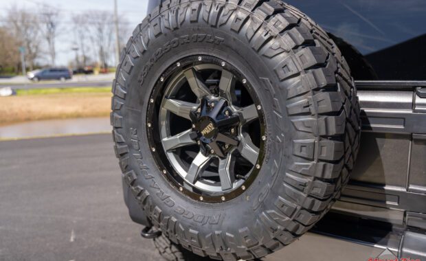 Moto Metal wheel with Nitto Ridge grappler tire on 5th wheel tire carrier on grey Jeep Wrangler