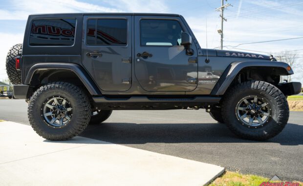 Grey 4 door jeep wrangler Sahara with Rough country suspension, Nitto Tires and Moto Metal wheels