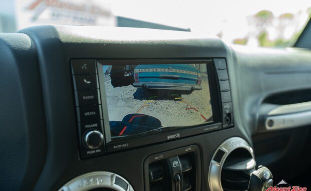 2017 Jeep Wrangler entertainment system close up of screen with backup camera active