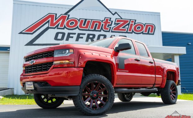 Rough Country lifted Red 2017 Chevy Silverado with red fender flares and black body stripe on Black and Red Fuel wheels with Falken tires at mount zion offroad