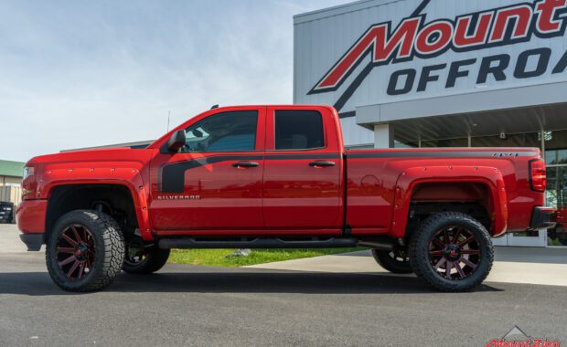 Rough Country lifted Red 2017 Chevy Silverado with red fender flares and black body stripe on Black and Red Fuel wheels at mount zion offroad