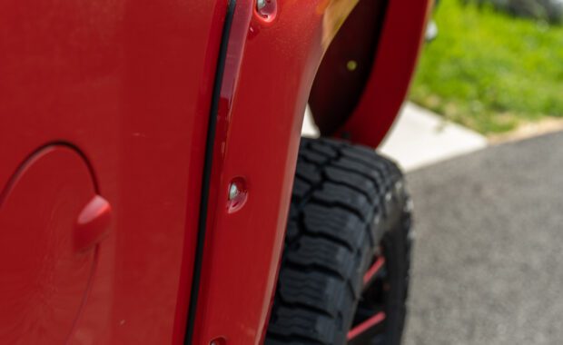 Red fender flares on 2017 Chevy Silverado 1500 rear driver side wheel well