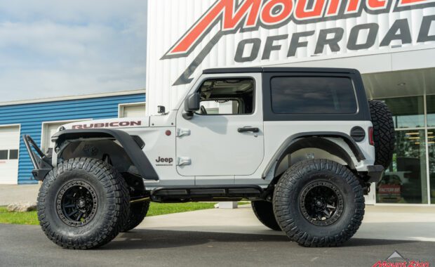 2022 Jeep wrangler rubicon on fuel wheels and nitto tires with front bumper push bar driver side view at mount zion offroad