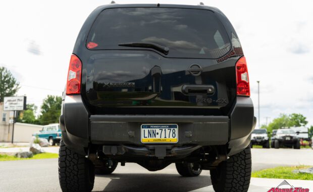 2011 Nissan Xterra with bilstein suspension on falken wildpeak tire and black rhino wheels tailgate