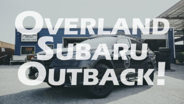 Overland subaru outback Youtube thumbnail showing black subaru outback with roof rack and black wheels