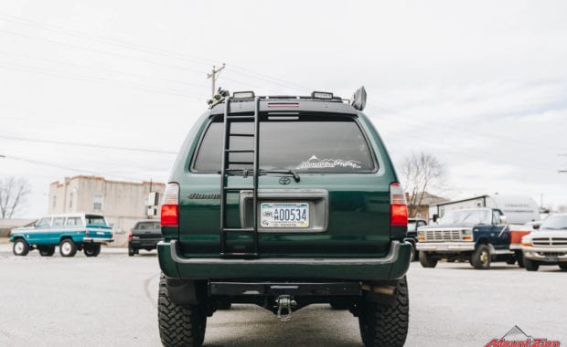 Green 4runner front grille with winch and roof rack with rear ladder rear tailgate view