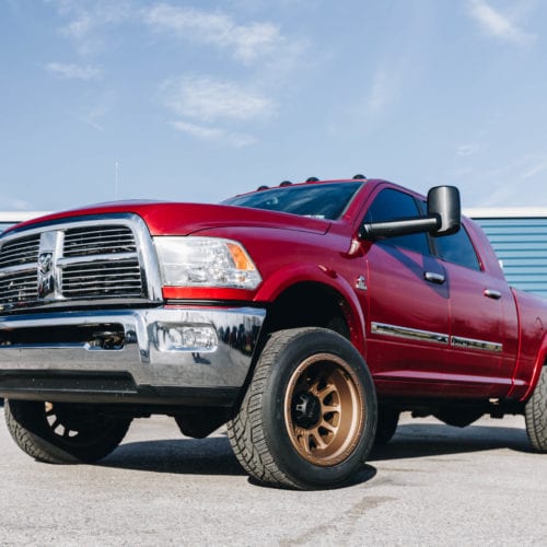 red dodge ram with method race wheels front driver side grille view