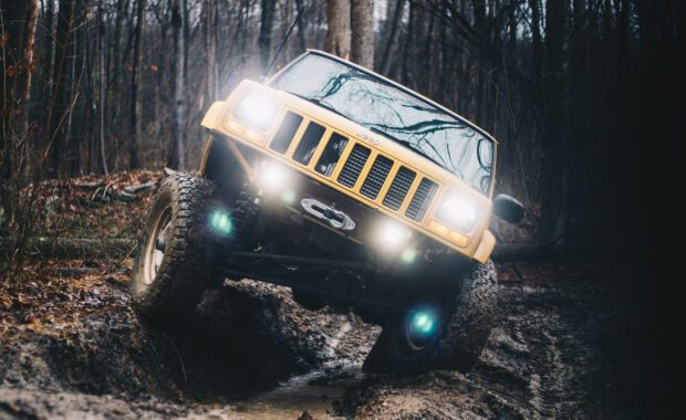 Yellow jeep crawling offroad