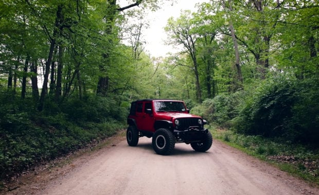 Red offroad Jeep wrangler Recon in forrest