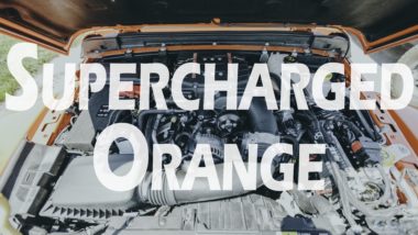Supercharged orange YouTube thumbnail featuring the engine bay of an orange jeep
