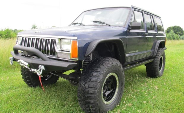 Blue lifted jeep with flares and bumper
