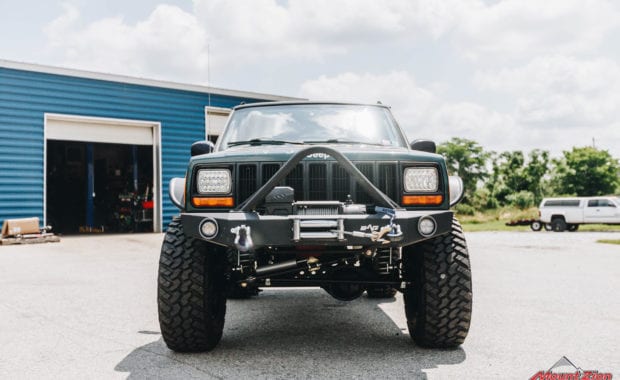 Green Jeep front end with offroad bumper and winch