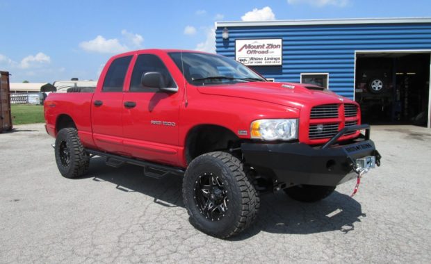 Red Dodge Ram with Road Armor bumper and upgrade wheels and tires