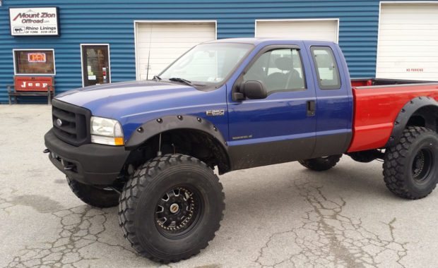 Lifted F250 with blue cab and red bed