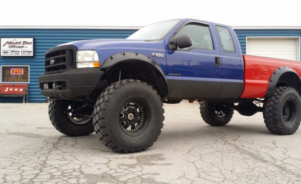 lifted F250 with blue cab and red bed