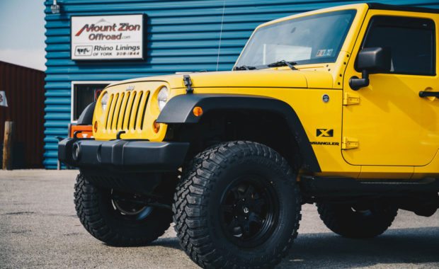 Two door yellow jeep wranlger with bilstein AEV suspension and fuel wheels front drivers side