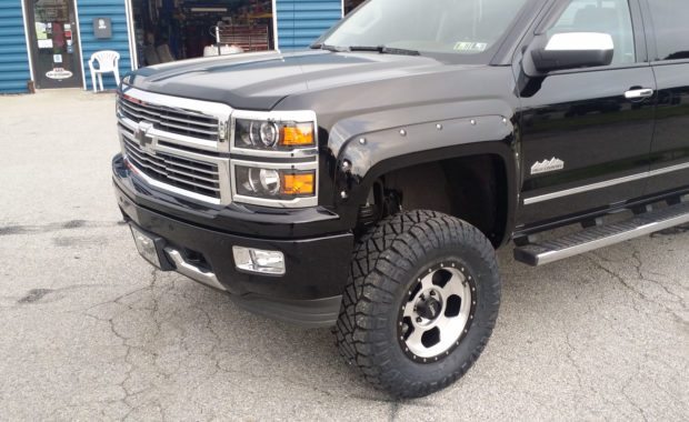 Lifted 2014 Black Chevrolet silverado with fender flares front driver side wheel well