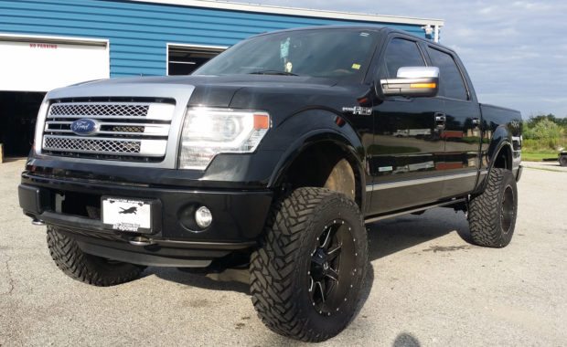 Black Ford F150 lifted with Fuel wheels front passenger side
