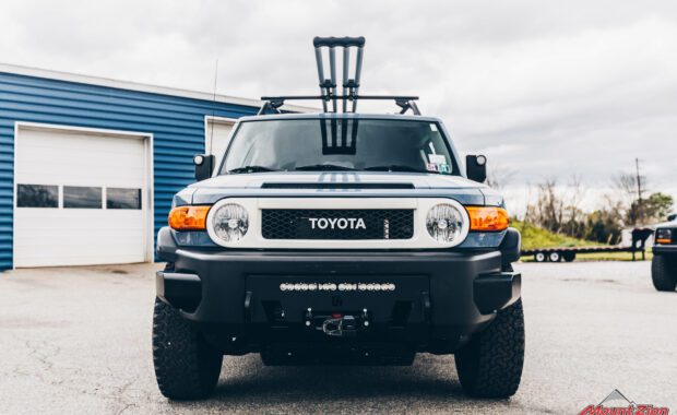 Blue FJ cruiser with roof rack front grille