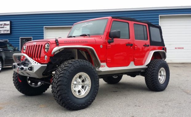 lifted red soft top jeep with winch