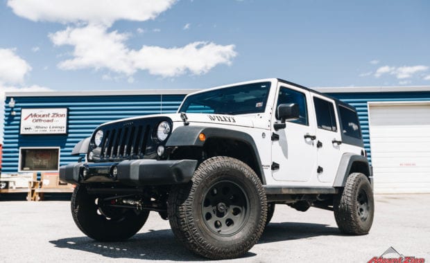 White 2015 Jeep Wrangler on Pro Comp Wheel with Pro Comp Tire front driver side grille view