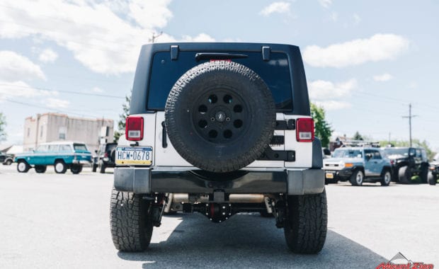 White 2015 Jeep Wrangler on Pro Comp Wheel with Pro Comp Tire with 5th wheel tire carrier rear tailgate view