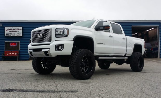 White 2017 GMC Denali lifted with Fuel Wheels front driver side at mount zion offroad shop