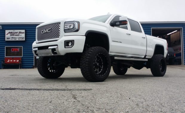 White 2017 GMC Denali lifted with Fuel Wheels front driver side at mount zion offroad low from ground